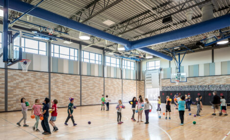 Children play in a school gym.